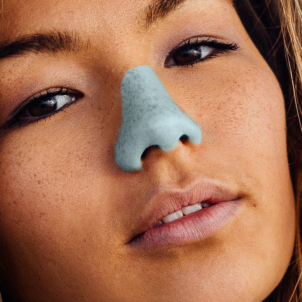 A confident and bold young woman wearing colorful sunscreen on her nose 